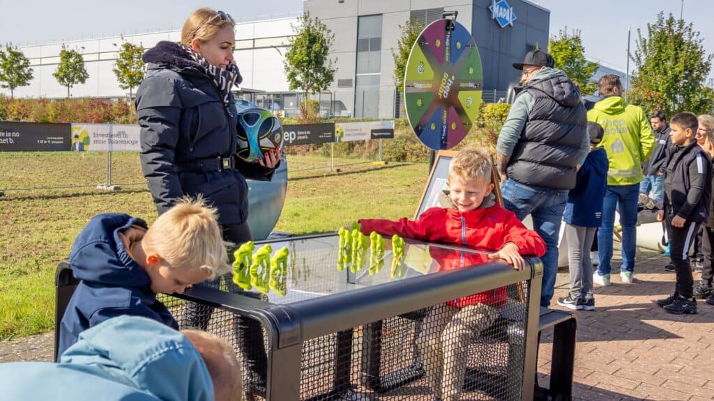 Kinder spielen an einem Kickertisch.